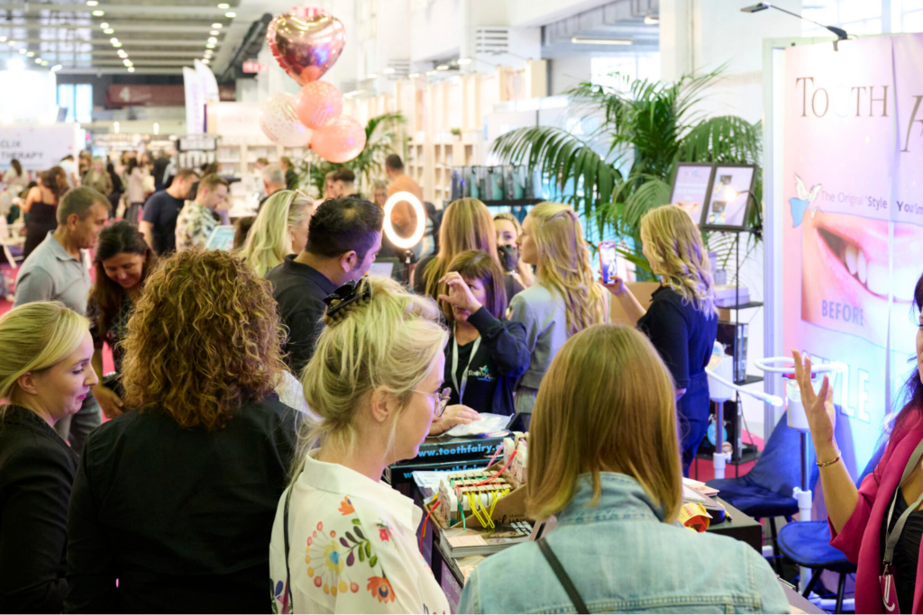 Attendees exploring beauty exhibits and product demonstrations at Estetika