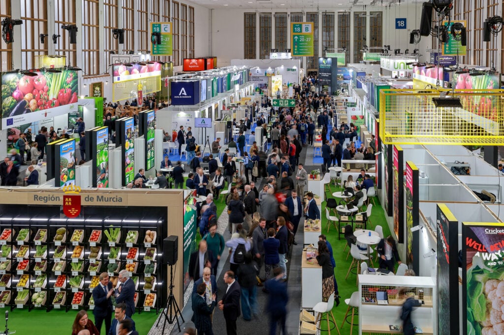 Attendees gathering at the busy trade show floor of Fruit Logistica