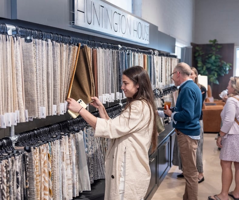 Visitors browsing fabric samples at High Point Market